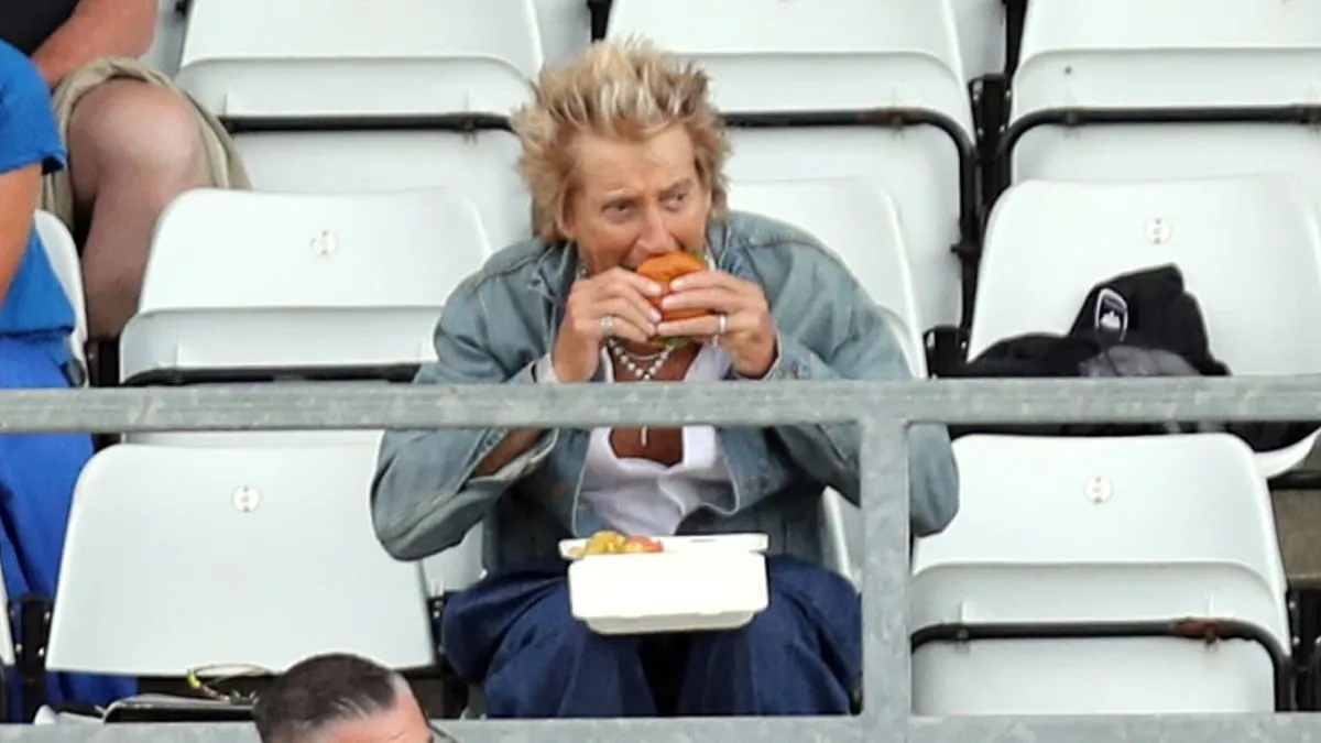 Rod Stewart, 81, tucks into a burger and chips as he watches his local football team with son Alastair, 20, after heart surgery